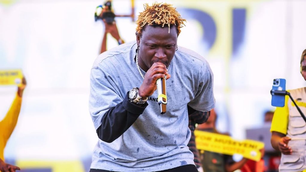 Gravity Omutujju falls off stage while dodging bottles at NRM rally – Sqoop